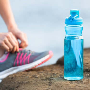 runner hydrating with drinking water