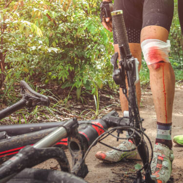 mountain biker with abrasion on injured knee